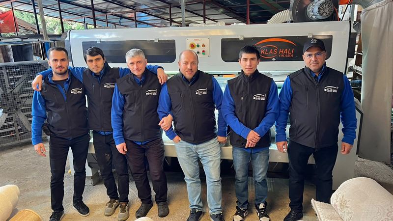 Klas Halı Yıkama ekibi tesisteki halı yıkama makinesinin önünde